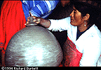 Pottery Maria smooths the surface of the olla with the clay mallets